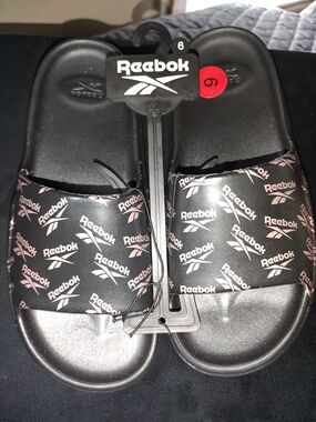 Brand New Reebok Black Slides with Pink Logo Pattern